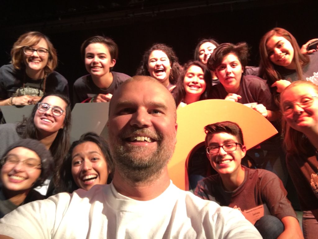 Caleb Munro surrounded by teens smiling